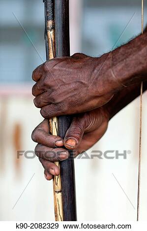 Papuan man holding his bow and arrow, Papua, Indonesia, Southeast Asia. View Large Photo Image Stock Photo - Papuan man holding his bow and arrow, Papua, Indonesia, Southeast Asia.. Fotosearch