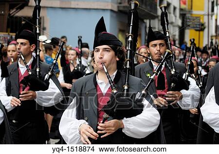 Picture - Parade of pipe bands through the streets of Llanes during the festival of San Roque, Llanes, Asturias, Spain.. Fotosearch