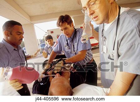 Paramedics rushing patient from ambulance to emergency in hospital View Large Photo Image Stock Photograph - Paramedics rushing patient from ambulance to emergency in hospital. Fotosearch