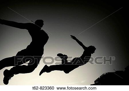 Parcours: Two boys practicing jumps to the dusk in the beach View Large Photo Image Stock Image - Parcours: Two boys practicing jumps to the dusk in the beach. Fotosearch