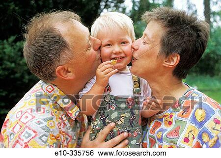 Parents kissing 2 year old boy View Large Photo Image Stock Photograph - Parents kissing 2 year old boy. Fotosearch