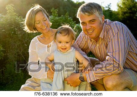 Parents with one year old daughter View Large Photo Image Stock Photograph - Parents with one year old daughter. Fotosearch