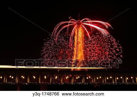 Parisians and tourists watching Bastile day fireworks around Eiffel Tower with Passy bridge in the foreground in Paris, France. View Large Photo Image Stock Photograph - Parisians and tourists watching Bastile day fireworks around Eiffel Tower with Passy bridge in the foreground in Paris, France.. Fotosearch