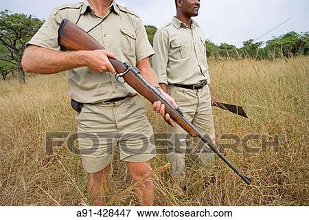 Park Rangers Ryan Kewley and Thomas Nsele. Game drive in the Phinda private park. Kwazulu-Natal province. South Africa View Large Photo Image Stock Photo - Park Rangers Ryan Kewley and Thomas Nsele. Game drive in the Phinda private park. Kwazulu-Natal province. South Africa. Fotosearch