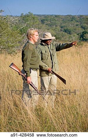 Park Rangers Ryan Kewley and Thomas Nsele. Game drive in the Phinda private park. Kwazulu-Natal province. South Africa View Large Photo Image Stock Photo - Park Rangers Ryan Kewley and Thomas Nsele. Game drive in the Phinda private park. Kwazulu-Natal province. South Africa. Fotosearch