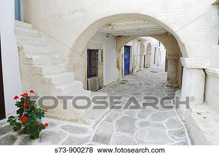 Paros white houses with typically colourful and door frames, and painted paving stones, Paros, Cyclades, Greece, Europe View Large Photo Image Stock Photo - Paros white houses with typically colourful and door frames, and painted paving stones, Paros, Cyclades, Greece, Europe. Fotosearch