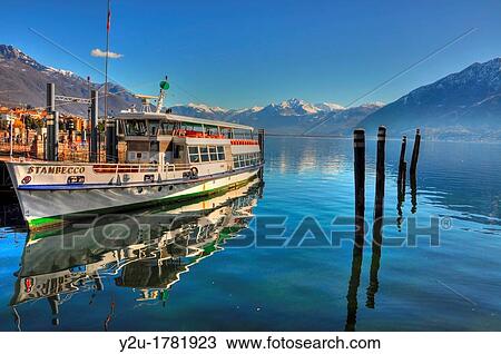 Passenger ship reflected on an alpine lake with snow-capped mountain and blue sky View Large Photo Image Stock Image - Passenger ship reflected on an alpine lake with snow-capped mountain and blue sky. Fotosearch
