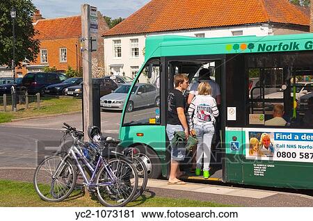 Passengers boarding a bus in The Popular North Norfolk village of Burnham Market in Norfolk Uk View Large Photo Image Stock Image - Passengers boarding a bus in The Popular North Norfolk village of Burnham Market in Norfolk Uk. Fotosearch