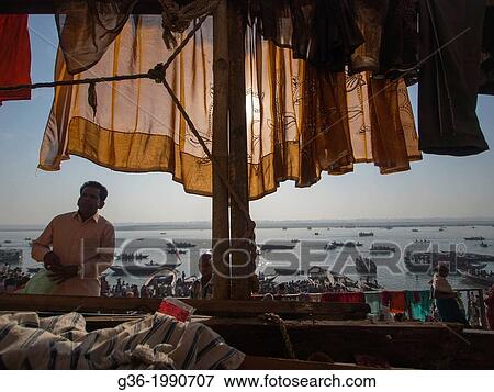 Stock Photo - Passengers boats on river, clothesline in foreground, Varanasi, Uttar Pradesh, India.. Fotosearch