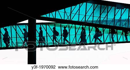 Passengers disembark from an aeroplane through the enclosed passage ramp. They are silhouetted against the sunlight View Large Photo Image Stock Image - Passengers disembark from an aeroplane through the enclosed passage ramp. They are silhouetted against the sunlight. Fotosearch