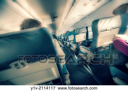 Passengers in an airplane. View Large Photo Image Stock Photo - Passengers in an airplane.. Fotosearch