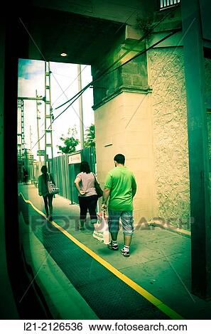 Stock Photograph - Passengers, train station. Barcelona province, Catalonia, Spain.. Fotosearch