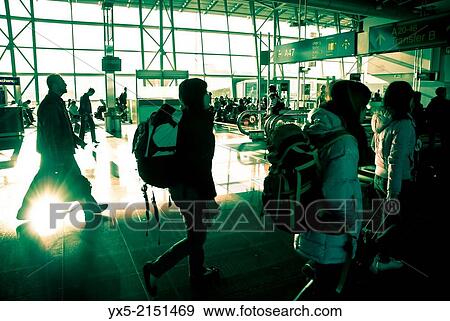 Stock Photo - Passengers walking towards departure gates in Brussels airport.. Fotosearch