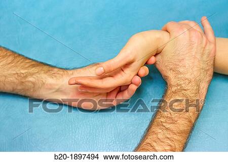 Picture - Passive mobilization of wrist extension Physiotherapy medical center, Donostia, San Sebastian, Gipuzkoa, Basque Country, Spain. Fotosearch
