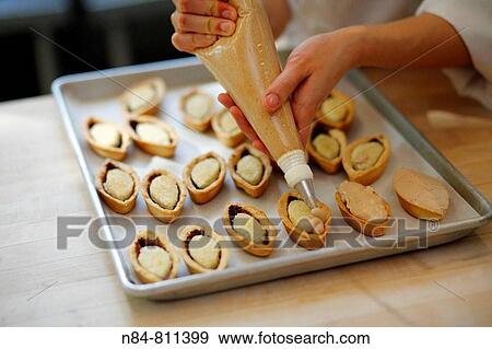 Pastry chef making small pastries View Large Photo Image Stock Photo - Pastry chef making small pastries. Fotosearch