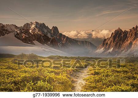 Path to a mountain range at sunset View Large Photo Image Stock Photograph - Path to a mountain range at sunset. Fotosearch