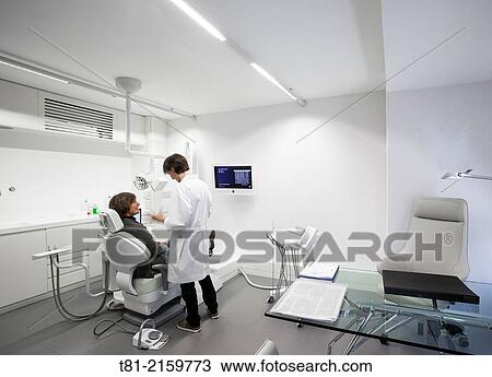 Patient and dentist in the doctor's office View Large Photo Image Stock Image - Patient and dentist in the doctor's office. Fotosearch