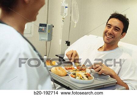 Patient in hospital, lunchtime View Large Photo Image Picture - Patient in hospital, lunchtime. Fotosearch