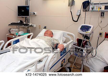 Stock Photography - Patient recovering in hospital bed. Fotosearch