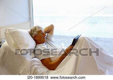 patient with tablet in hospital room, Onkologikoa Hospital, Oncology Institute, Case Center for prevention, diagnosis and treatment of cancer, Donostia, San Sebastian, Gipuzkoa, Basque Country, Spain View Large Photo Image Stock Photo - patient with tablet in hospital room, Onkologikoa Hospital, Oncology Institute, Case Center for prevention, diagnosis and treatment of cancer, Donostia, San Sebastian, Gipuzkoa, Basque Country, Spain. Fotosearch