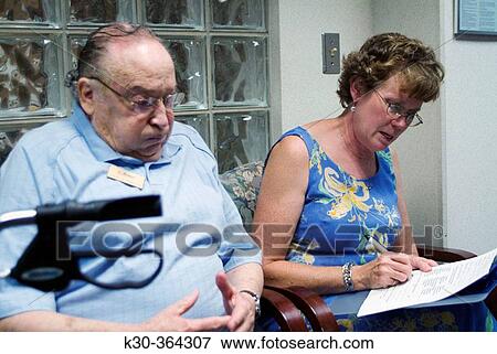 Stock Photo - Patients in doctor's waiting room. Fotosearch