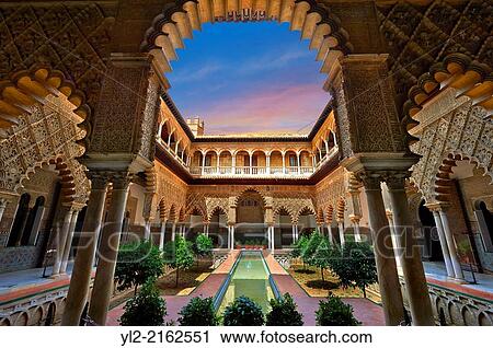 Stock Image - Patio de las Doncellas (Courtyard of the Maidens) an Italian Renaissance courtyard (1540-72) with Arabesque Mud? jar style plaster work, Alcazar of Seville, Seville, Spain.. Fotosearch