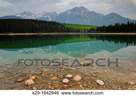 Stock Photograph - Patricia Lake at dawn with reflections of Pyramid Mountain, Jasper National Park, Alberta, Canada. Fotosearch