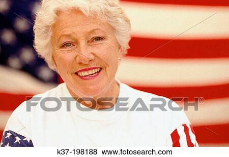 Patriotic mature American woman in front of U. S. flag View Large Photo Image Stock Photo - Patriotic mature American woman in front of U. S. flag. Fotosearch