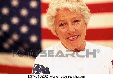 Patriotic mature woman with U. S. flag in background View Large Photo Image Stock Image - Patriotic mature woman with U. S. flag in background. Fotosearch
