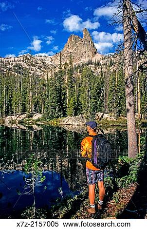 pause at a small lake while hiking to The Finger Of Fate for a rock climb of The Open Book route in the Sawtooth Mountains of central Idaho. View Large Photo Image Stock Photography - pause at a small lake while hiking to The Finger Of Fate for a rock climb of The Open Book route in the Sawtooth Mountains of central Idaho.. Fotosearch