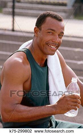 Pausing for a drink of water after exercising View Large Photo Image Stock Image - Pausing for a drink of water after exercising. Fotosearch