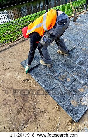 paviour at work in street in the Netherlands View Large Photo Image Stock Photo - paviour at work in street in the Netherlands. Fotosearch