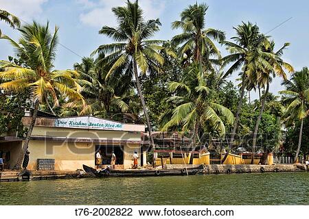 Stock Image - peaceful canal life in the backwaters of Kerala, India.. Fotosearch