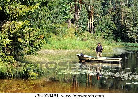 Stock Image - pecheur sur une barque dans la region de Torva, Estonie, pays balte, europe du nord. Fotosearch