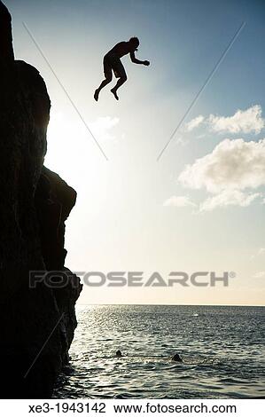 Stock Image - Peculiar jump, Waimea Bay, Oahu, Hawaii.. Fotosearch