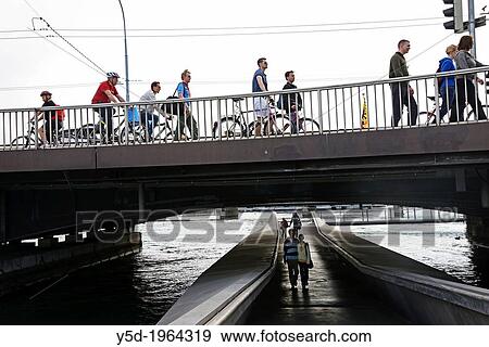 Stock Photo - pedestrian traffic on Mont Blanc bridge and passage under the bridge, Rhone river, Geneva, Switzerland. Fotosearch