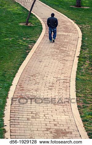 Pedestrian walking along a bike lane, old river bed Turia, Valencia, Spain View Large Photo Image Stock Photo - Pedestrian walking along a bike lane, old river bed Turia, Valencia, Spain. Fotosearch