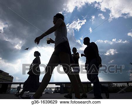 Pedestrians walk on the High Line in New York, New York, United States View Large Photo Image Stock Photo - Pedestrians walk on the High Line in New York, New York, United States. Fotosearch