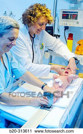 Pediatrician and nurse examinating baby at hospital View Large Photo Image Stock Image - Pediatrician and nurse examinating baby at hospital. Fotosearch