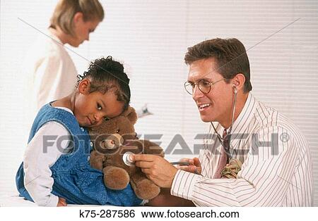 Pediatrician and patient with teddy bear View Large Photo Image Stock Photograph - Pediatrician and patient with teddy bear. Fotosearch