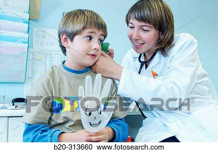 Stock Image - Pediatrician examinating 6 year old boy at pediatrics section of hospital. Fotosearch