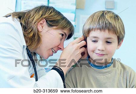 Pediatrician examinating 6 year old boy at pediatrics section of hospital View Large Photo Image Stock Photo - Pediatrician examinating 6 year old boy at pediatrics section of hospital. Fotosearch