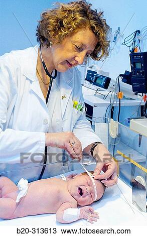 Pediatrician examinating baby at hospital View Large Photo Image Stock Image - Pediatrician examinating baby at hospital. Fotosearch