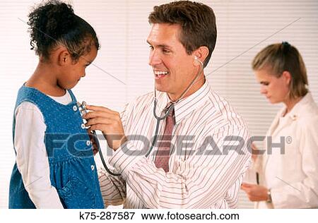 Stock Photo - Pediatrician listening to heart beat of little girl. Fotosearch