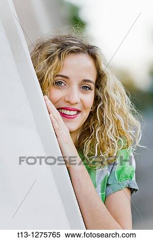 Peeking behind a corner young blonde woman View Large Photo Image Stock Photography - Peeking behind a corner young blonde woman. Fotosearch