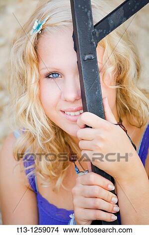 Peeking behind iron bar shy teen girl View Large Photo Image Picture - Peeking behind iron bar shy teen girl. Fotosearch