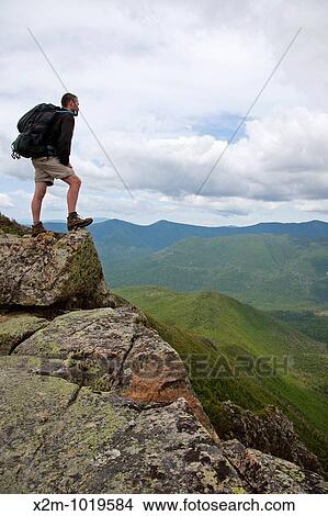 Pemigewasset Wilderness - A hiker on the summit of Bondcliff during the summer months Located in the White Mountains, New Hampshire USA View Large Photo Image Picture - Pemigewasset Wilderness - A hiker on the summit of Bondcliff during the summer months Located in the White Mountains, New Hampshire USA. Fotosearch