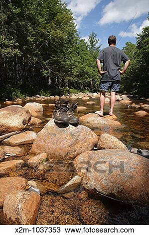 Pemigewasset Wilderness - Hiker and hiking boots drying off on rocks along the North Fork East Branch Pemigewasset River during the summer months in Lincoln, New Hampshire USA View Large Photo Image Stock Image - Pemigewasset Wilderness - Hiker and hiking boots drying off on rocks along the North Fork East Branch Pemigewasset River during the summer months in Lincoln, New Hampshire USA. Fotosearch