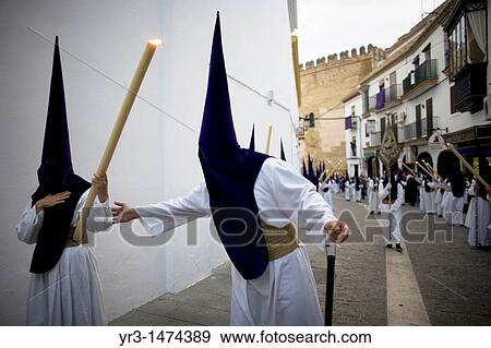 Stock Photo - Penitents perform in an Easter Holy Week procession in Carmona village, Seville province, Andalusia, Spain, April 19, 2011. Fotosearch
