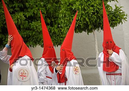 Penitents stand outside a church after an Easter Holy Week procession in Carmona village, Seville province, Andalusia, Spain, April 19, 2011 View Large Photo Image Stock Photo - Penitents stand outside a church after an Easter Holy Week procession in Carmona village, Seville province, Andalusia, Spain, April 19, 2011. Fotosearch
